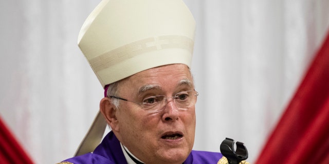 FILE - In this Dec. 18, 2017, file photo, Philadelphia Archbishop Charles Chaput celebrates Mass with inmates at the Curran-Fromhold Correctional Facility in Philadelphia. The Vatican announced Thursday, Jan. 23, 2020, Chaput, who will step down after turning 75 last year, the traditional retirement age for Catholic bishops, will be replaced by bishop of Cleveland Nelson Perez. (AP Photo/Matt Rourke, File)