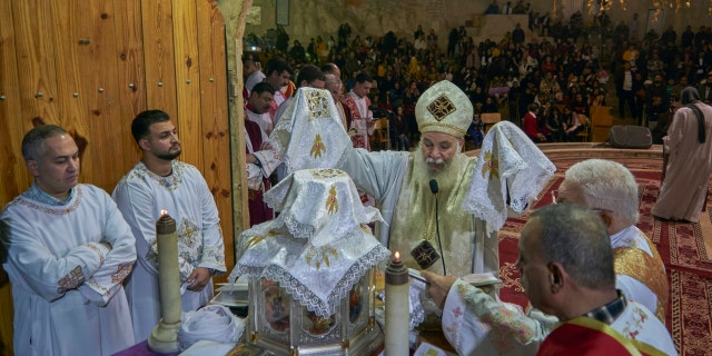 Coptic Christians attend Christmas eve mass at Saint Saman church in eastern Cairo, Egypt. Monday, Jan. 6, 2020. (AP Photo/Hamada Elrasam)