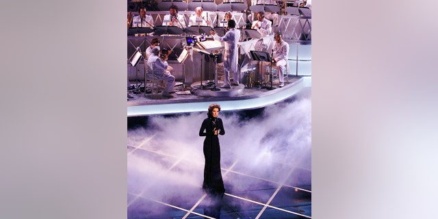 Celine Dion performs "My Heart Will Go On" during the 70th Academy Awards at the Shrine Auditorium during the 70th Academy Awards. "My Heart Will Go On" won the Oscar for best original song.