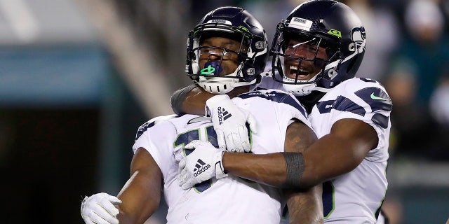 Seattle Seahawks' D.K. Metcalf, left, and David Moore celebrating after Metcalf's touchdown catch against the Philadelphia Eagles on Sunday. (AP Photo/Julio Cortez)