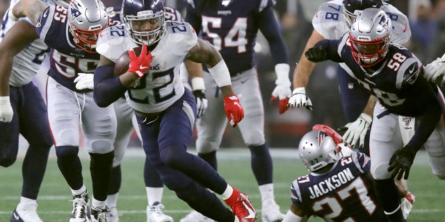 Tennessee Titans running back Derrick Henry runs from New England Patriots defenders in the first half of an NFL wild-card playoff football game, Saturday, Jan. 4, 2020, in Foxborough, Mass. (AP Photo/Charles Krupa)