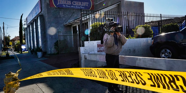 Crime scene tape is seen closing off an area around the grounds of the Kingdom of Jesus Christ Church in the Van Nuys section of Los Angeles on Wednesday. (AP Photo/Richard Vogel)