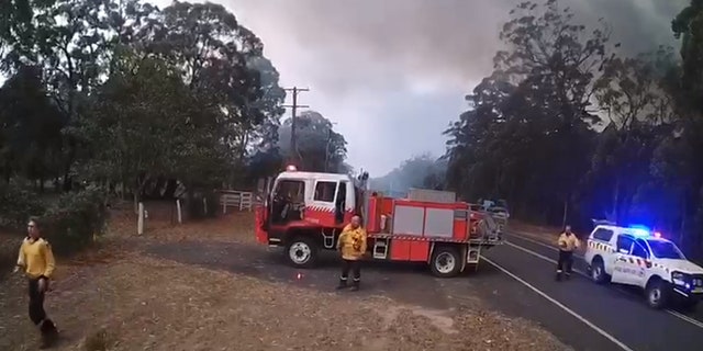 Firefighters can be seen preparing to flee the area.
