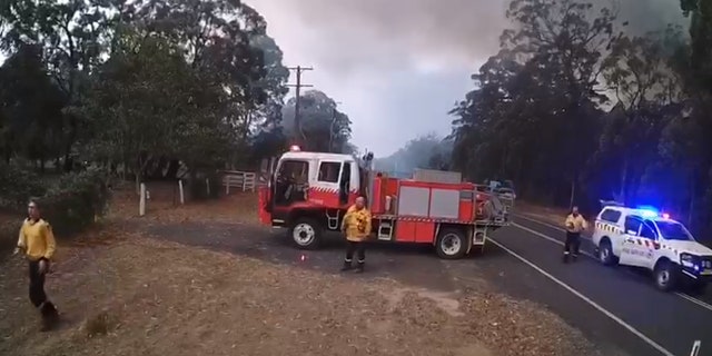 Firefighters can be seen preparing to flee the area.