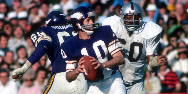 Fran Tarkenton #10 of the Minnesota Vikings drops back to pass pressured by Otis Sistrunk #60 of the Oakland Raiders during Super Bowl XI on January 9, 1977 at the Rose Bowl in Pasadena, California. The Raiders won the Super Bowl 32 -14. (Photo by Focus on Sport/Getty Images)