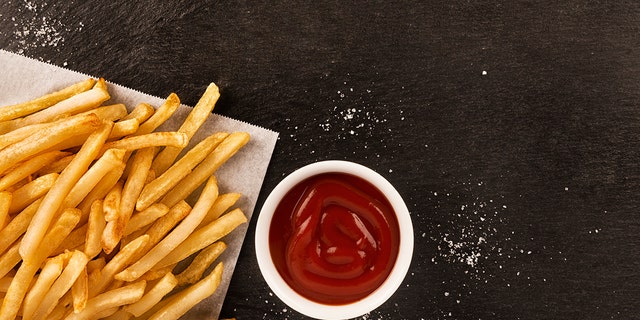 French fries are commonly served with salt and ketchup.