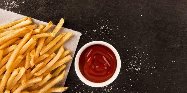 French fries are commonly served with salt and ketchup.