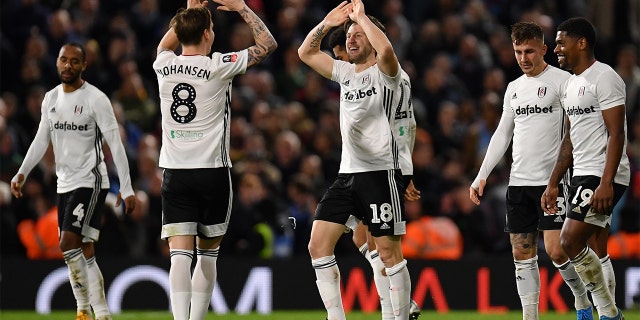 Harry Arter of Fulham celebrates scoring the second Fulham goal with teammates during the FA Cup Third Round match between Fulham FC and Aston Villa at Craven Cottage on January 04. The team is wearing its signature white jerseys. (Photo by Justin Setterfield/Getty Images)