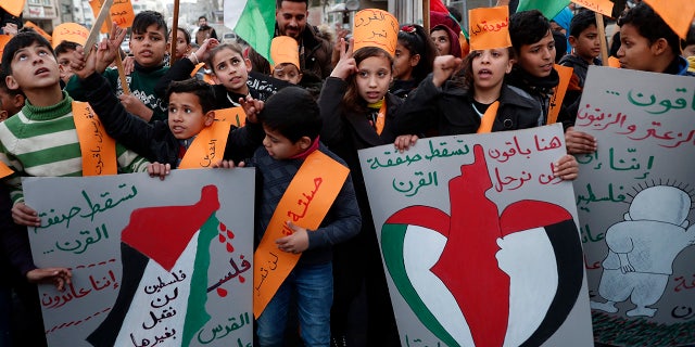 After historic Israel-UAE flight, other Muslim-majority countries considering to follow suit 4 Protesters hold placards as others wave their national flags during a protest against the Mideast plan announced by President Trump, at Jebaliya refugee camp, Gaza Strip, Thursday, Jan. 30, 2020. (AP Photo/Adel Hana)
