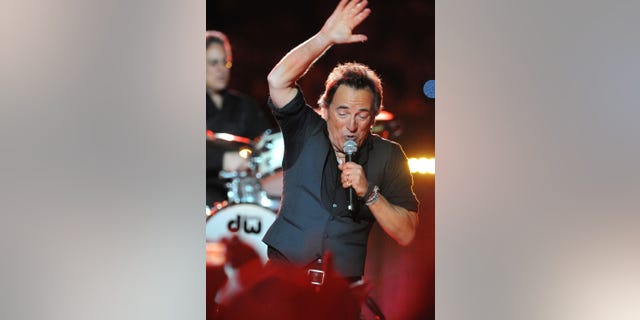 Musician Bruce Springsteen and the E Street Band perform at the Bridgestone halftime show during Super Bowl XLIII.