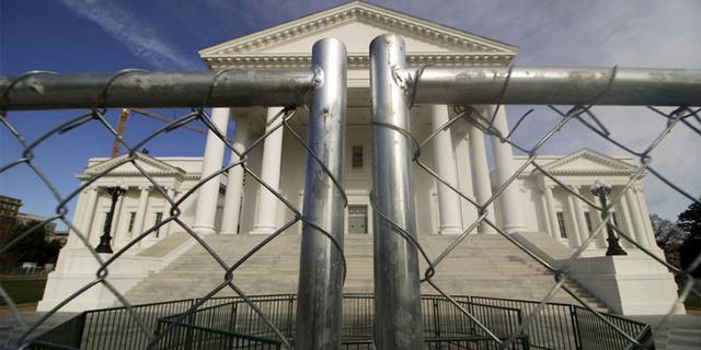 The Virginia Capitol building surrounded by fencing this past Thursday in preparation for Monday's rally by gun-rights advocates. (Dean Hoffmeyer/Richmond Times-Dispatch via AP)