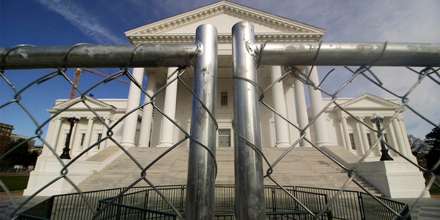 The Virginia state Capitol building is surrounded by fencing, Thursday, Jan. 16, 2020, in Richmond, Va., in preparation for Monday's rally by gun rights advocates. (Dean Hoffmeyer/Richmond Times-Dispatch via AP)