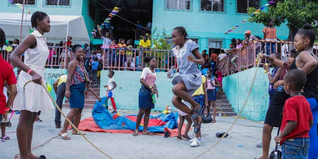 School children and their families participate in a funfair day at an earthquake-proof school built by Compassion that opened in 2013.