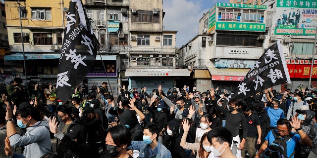 Protesters march Sunday during a demonstration against "parallel traders" who buy goods in Hong Kong to resell in mainland China. (AP Photo/Andy Wong)