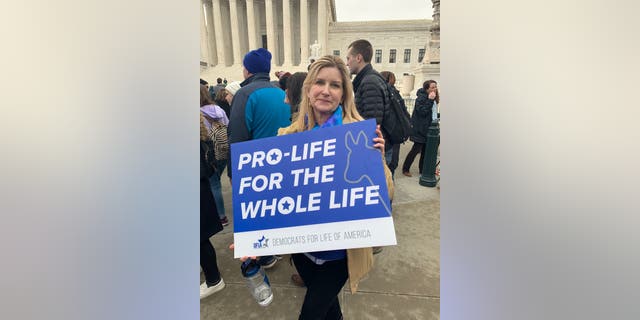 Jeannie French, 59, of Pittsburgh holds a Democrats for Life sign outside of the Supreme Court on Friday, Jan. 24.