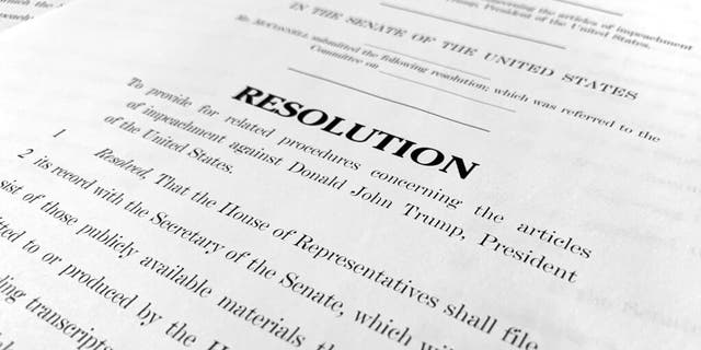 A copy of a Senate draft resolution to be offered by Senate Majority Leader Mitch McConnell, R-Ky., regarding the procedures during the impeachment trial of President Donald Trump in the U.S. Senate. (AP Photo/Jon Elswick)