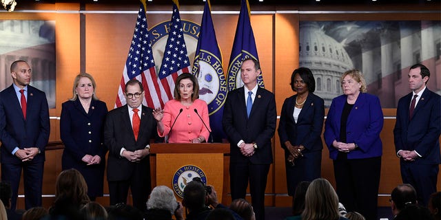 House Speaker Nancy Pelosi of Calif., fourth from left, speaks during a news conference to announce impeachment managers on Capitol Hill in Washington, Wednesday, Jan. 15, 2020.  (AP Photo/Susan Walsh)