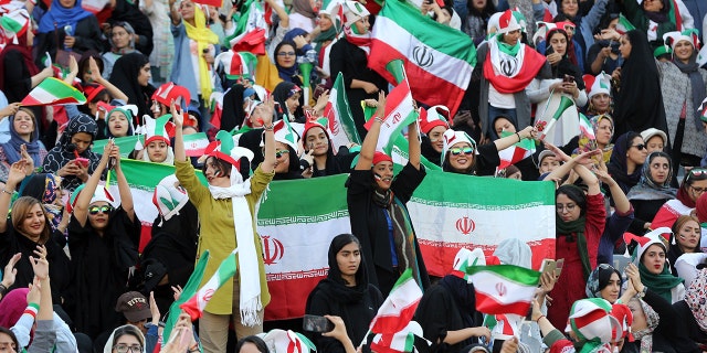 Iranian fans support their national football team during 2022 FIFA World Cup Asia qualifications Group C soccer match between Iran and Cambodia at Azadi Stadium in Tehran, Iran.  The Asian Football Confederation (AFC) has banned the country from hosting international matches. (Photo by Stringer /Anadolu Agency via Getty Images)