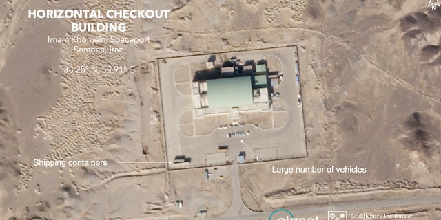 A satellite image taken on Sunday shows a large number of vehicles and shipping contains at a building at Iran's Imam Khomeini Spaceport. (Planet Labs Inc. Middlebury Institute of International Studies via AP)