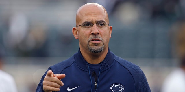 FILE - This file photo from Oct. 26, 2019 shows Penn State coach James Franklin as he watches the team warm before an NCAA college football game against Michigan State, in East Lansing, Mich. 