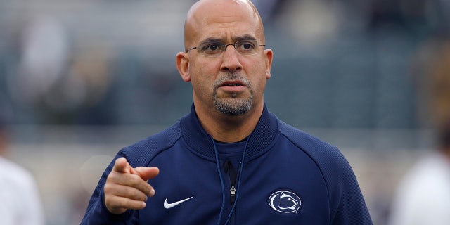 FILE - This file photo from Oct. 26, 2019 shows Penn State coach James Franklin as he watches the team warm before an NCAA college football game against Michigan State, in East Lansing, Mich.