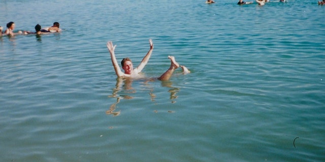 Jason Cohen, who went on the first Birthright Israel trip in 2000, floats in the Dead Sea with his group from Hofstra University Hillel.
