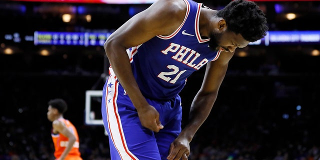 In this photo taken Jan. 6, 2020, Joel Embiid looks at his injured finger during an NBA basketball game against the Oklahoma City Thunder in Philadelphia. Embiid injured the radial collateral ligament in the ring finger in the first half Monday night against Oklahoma City.