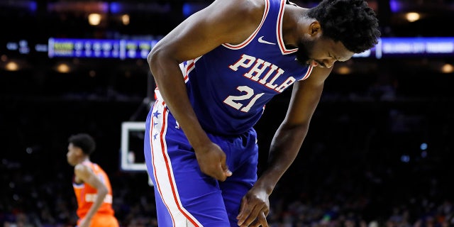 In this photo taken Jan. 6, 2020, Joel Embiid looks at his injured finger during an NBA basketball game against the Oklahoma City Thunder in Philadelphia. Embiid injured the radial collateral ligament in the ring finger in the first half Monday night against Oklahoma City.