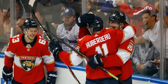 Florida Panthers left wing Jonathan Huberdeau (11) is congratulated by center Aleksander Barkov (16) and right wing Evgenii Dadonov (63) after he scored a goal during the second period of an NHL hockey game against the Toronto Maple Leafs, Sunday, Jan. 12, 2020, in Sunrise, Fla. (AP Photo/Wilfredo Lee)