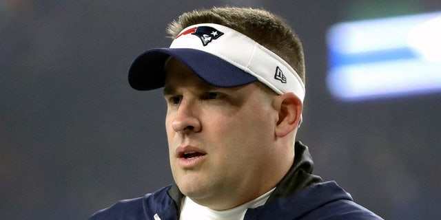 New England Patriots offensive coordinator Josh McDaniels watches his team warm up before the NFL wild-card playoff game against the Tennessee Titans on Jan. 4, 2020, in Foxborough, Massachusetts. (AP Photo/Elise Amendola, File)