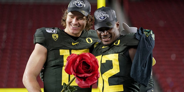Oregon Ducks quarterback Justin Herbert and linebacker La'Mar Winston Jr. (right) on Dec. 6, 2019, in Santa Clara, Calif., after the game against the Utah Utes at Levi's Stadium. Mandatory Credit: Kyle Terada - USA TODAY Sports