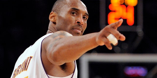 June 7, 2009: Los Angeles Lakers guard Kobe Bryant (24) points to a player behind him after making a basket in the closing seconds against the Orlando Magic in Game 2 of the NBA basketball finals, in Los Angeles. Bryant, the 18-time NBA All-Star who won five championships and became one of the greatest basketball players of his generation during a 20-year career with the Los Angeles Lakers, died in a helicopter crash Sunday, Jan. 26, 2020. (AP Photo/Mark J. Terrill, File)