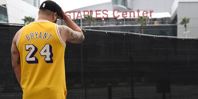 Gennesys Cabral, of Los Angeles, wearing a Kobe Bryant jersey outside the Staples Center on Sunday. (AP Photo/Chris Pizzello)