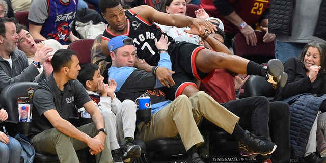 Toronto Raptors guard Kyle Lowry (7) falls in to the stands in the fourth quarter against the Cleveland Cavaliers at Rocket Mortgage FieldHouse. (David Richard-USA TODAY Sports)