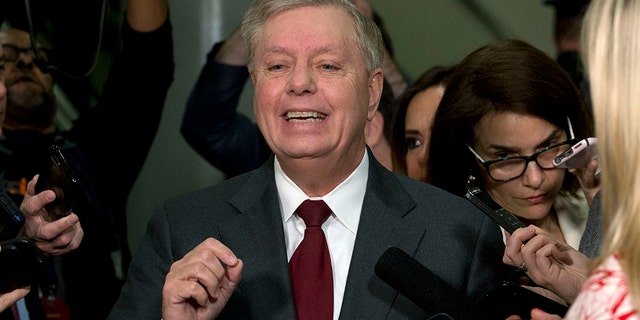 Sen. Lindsey Graham, R-S.C., speaks to the media before attending the impeachment trial of President Trump on charges of abuse of power and obstruction of Congress, Thursday, Jan. 23, 2020, on Capitol Hill in Washington. (AP Photo/Jose Luis Magana)