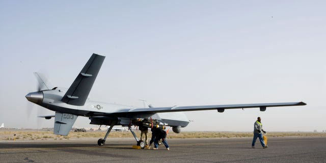 Aircrews perform a preflight check on an MQ-9 Reaper before it takes of for a mission in Afghanistan Sept. 31. The Reaper is larger and more heavily-armed than the MQ-1 Predator and in addition to its traditional ISR capabilities, is designed to attack time-sensitive targets with persistence and precision, and destroy or disable those targets. (Courtesy of the United States Air Force)