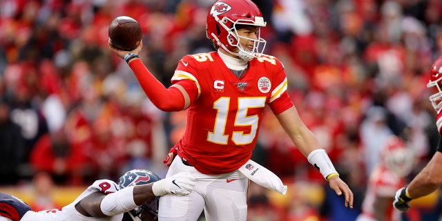 Kansas City Chiefs quarterback Patrick Mahomes (15) throws under pressure from Houston Texans defensive end Charles Omenihu (94) during the first half of an NFL divisional playoff football game, in Kansas City, Mo., Sunday. (AP Photo/Jeff Roberson)