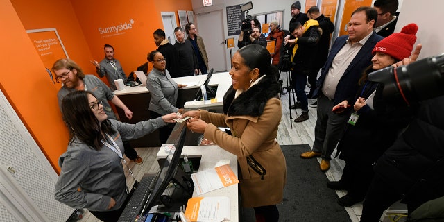 Illinois Lt. Gov. Juliana Stratton purchases recreational marijuana at Sunnyside dispensary Wednesday, Jan. 1, 2020, in Chicago. (AP Photo/Paul Beaty)