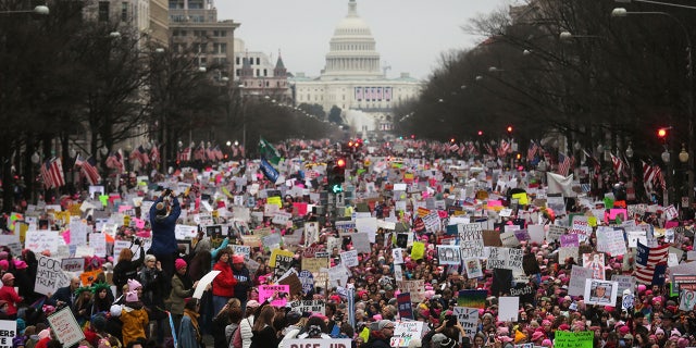 WASHINGTON, DC - JANUARY 21: Protesters walk during the Women's March on Washington, with the U.S. Capitol in the background, on January 21, 2017 in Washington, DC. Large crowds are attending the anti-Trump rally a day after U.S. President Donald Trump was sworn in as the 45th U.S. president. (Photo by Mario Tama/Getty Images)
