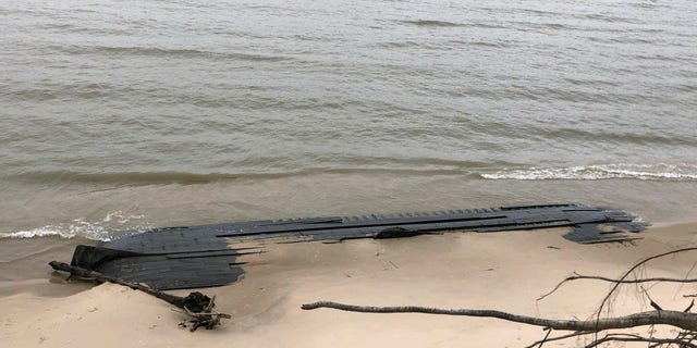 The wreck is slowly being reclaimed by Lake Michigan.
