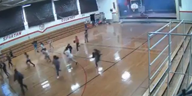 Students can be seen running as the roof begins to fall in when a microburst hit the area.