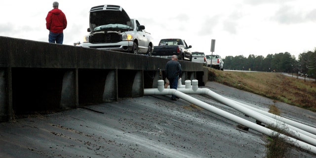 County officials work on the Oktibbeha County Lake Dam, Tuesday, Jan. 14, 2020, near Starkville, Miss., after County Engineer Clyde Pritchard warned the dam's failure was imminent.