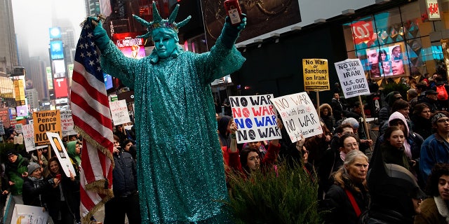 People marched as they take part in an anti-war protest at Times Square. (REUTERS/Eduardo Munoz)