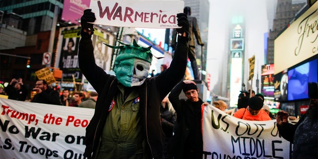 People took part in an anti-war protest at Times Square in New York. (REUTERS/Eduardo Munoz)