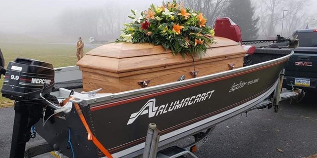 Frey’s brother Jeremy placed a wooden platform inside his fishing boat and transported the casket from the church to the cemetery.