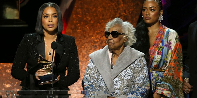 Lauren London, from left, Margaret Boutte, and Samantha Smith accept the award for best rap performance for "Racks in the Middle" on behalf of Nipsey Hussle at the 62nd annual Grammy Awards on Sunday, Jan. 26, 2020, in Los Angeles.
