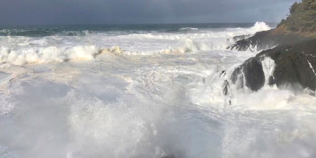 In this Saturday, Jan. 11, 2020, photo strong waves crash on the seashore near Otter Rock in Lincoln County, Ore.