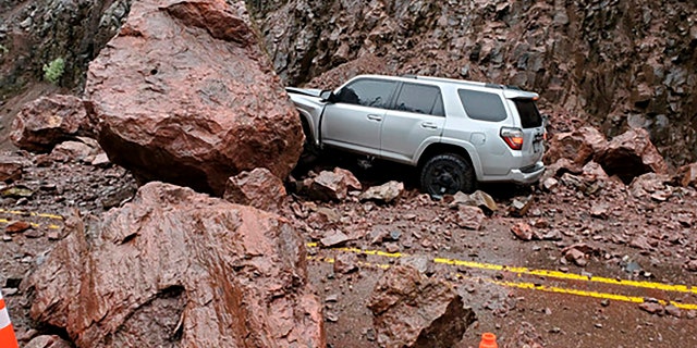 This photo provided by The Oregon Department of Transportation shows two enormous boulders that fell onto Highway 62, almost crushing a car outside of Prospect, Ore., Tuesday.