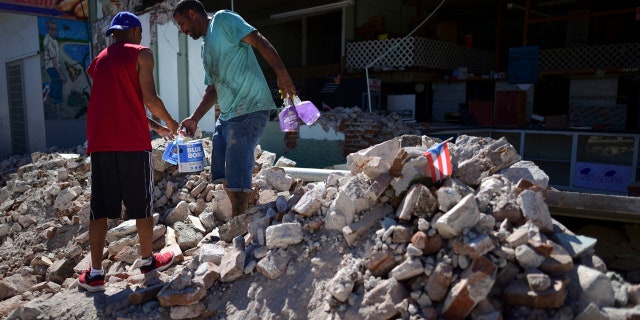 Store owners and family help remove supplies from Ely Mer Mar hardware store, which partially collapsed after an earthquake struck Guanica, Puerto Rico, Tuesday, Jan. 7, 2020.