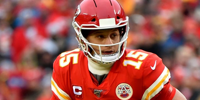 Mahomes scrambling during the first half of the playoff game against the Texans. (AP Photo/Ed Zurga)